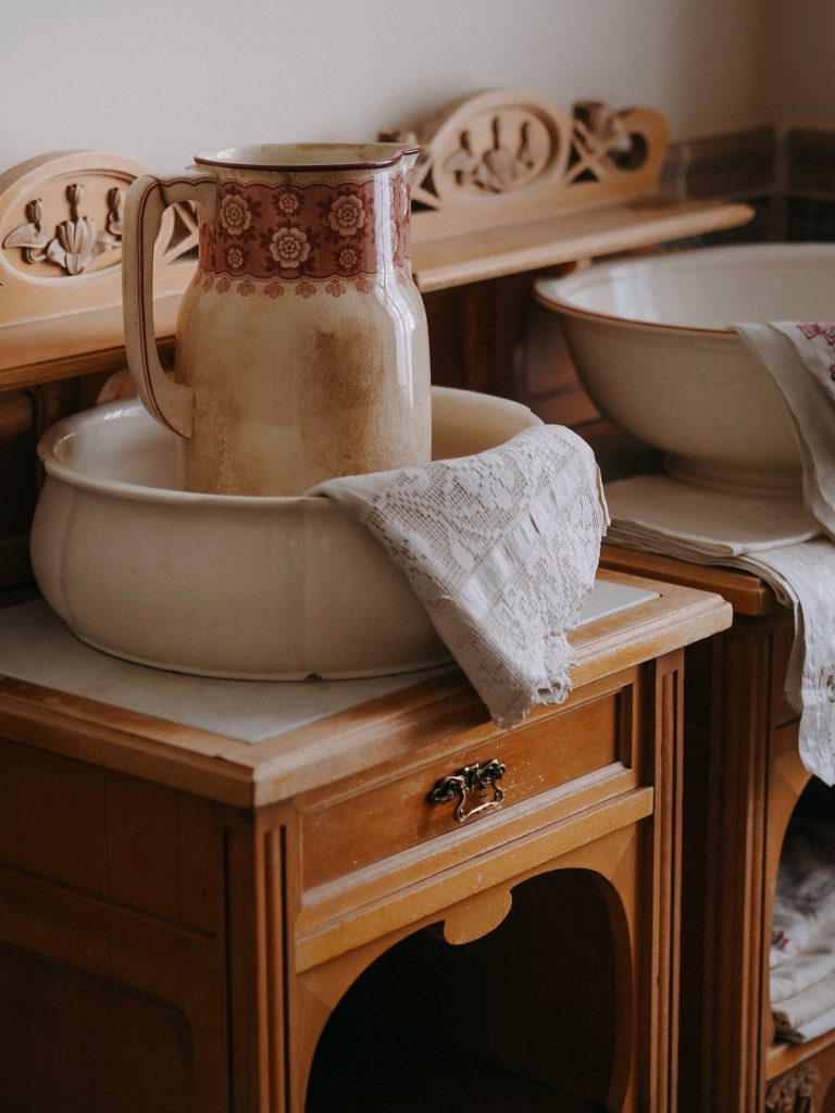 vintage jug on an old dresser in a vintage bathroom at home