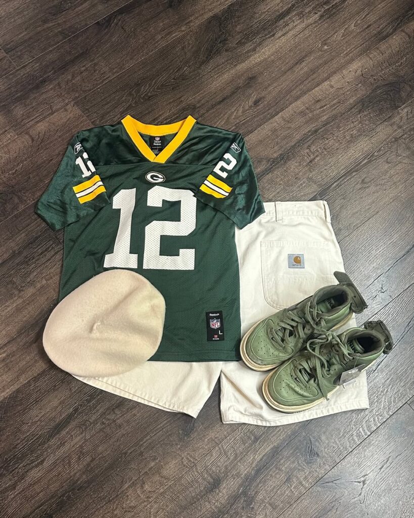 Vintage NFL jersey, Carhartt shorts, green sneakers