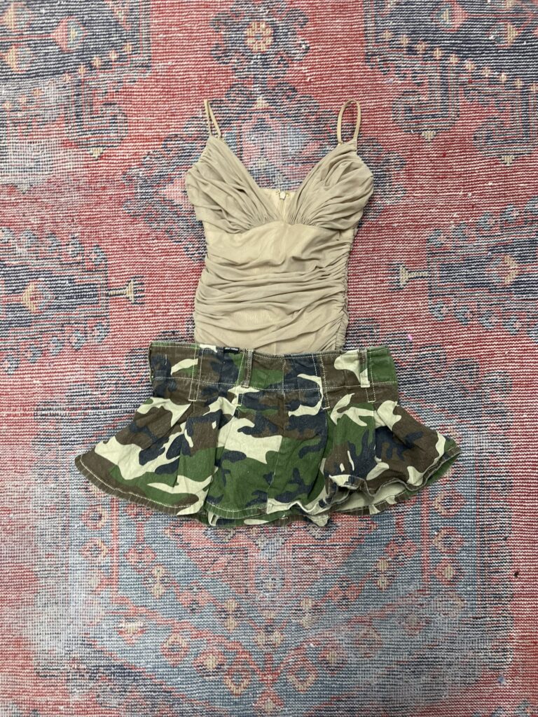 eige ruched tank top with ruffled camo mini skirt on tribal rug background